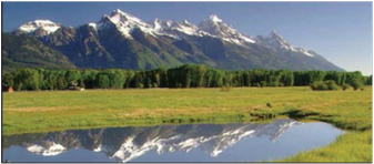 Picture of the snow capped Teton mountain range in summer.